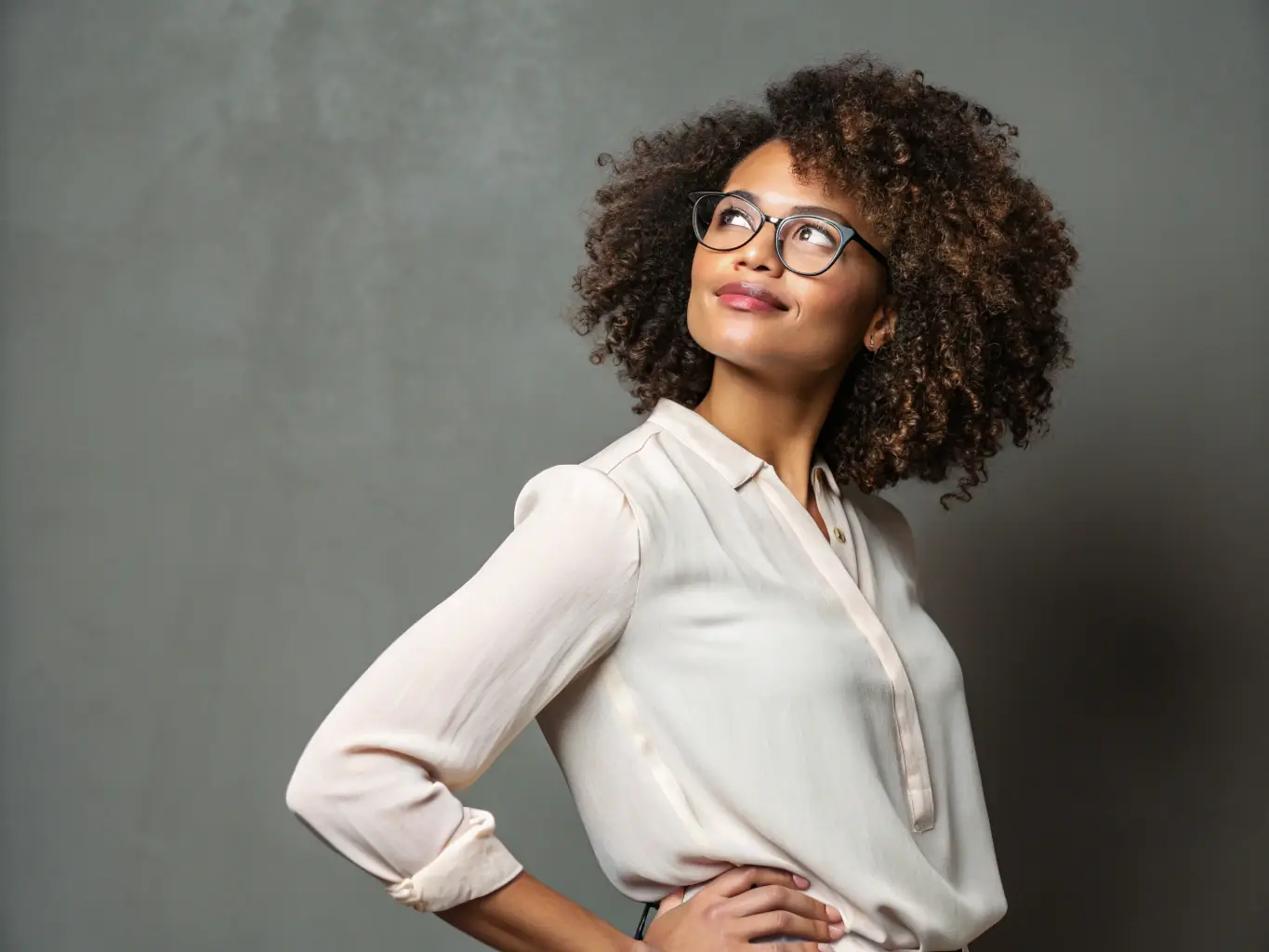 A professional headshot of a diverse woman, Ms. Aisha Khan, in business casual attire, smiling confidently. The background is a vibrant co-working space.