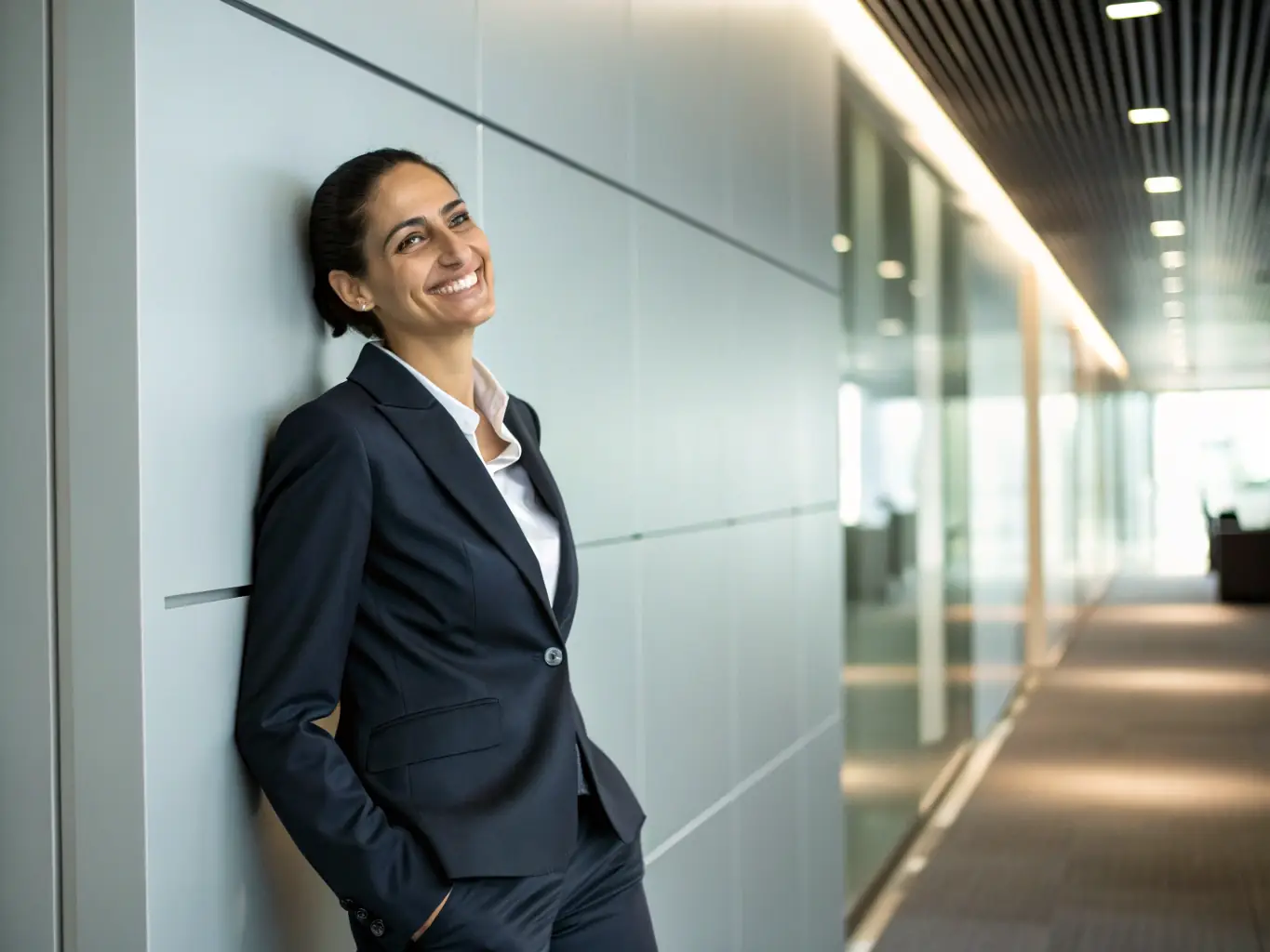 A professional headshot of a confident woman, Dr. Emily Carter, in business attire, smiling warmly. The background is a blurred image of a conference setting.